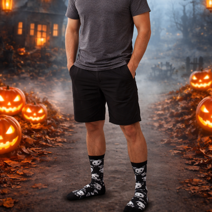 Person standing in a Halloween-themed setting with pumpkins and a misty background