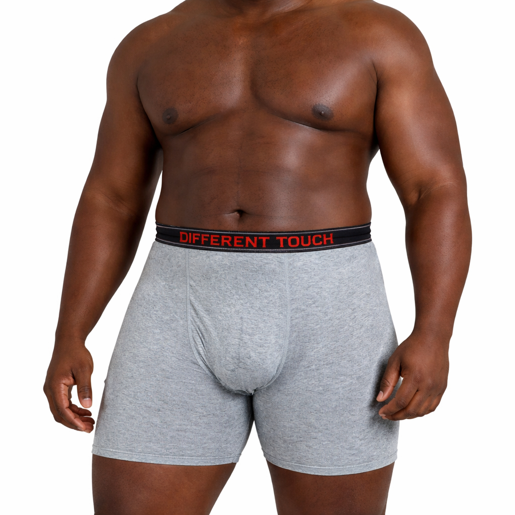 Man wearing gray boxer briefs with a visible brand label on a white background