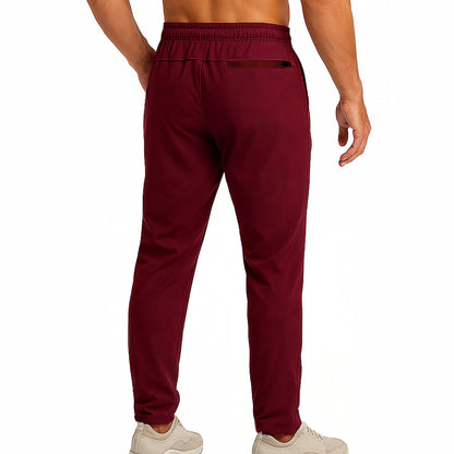 Maroon sweatpants worn by a person on a white background