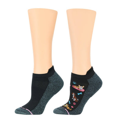 A pair of compression socks with a pattern of dogs and bones on one foot, and a plain dark color on the other foot, displayed against a white background.