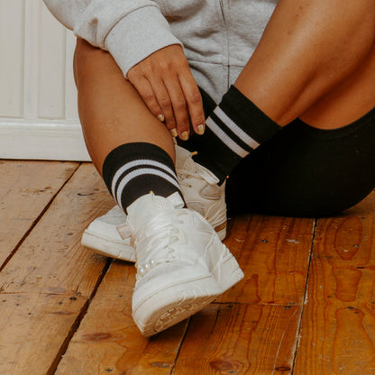 Woman wearing black dr. motion mid-crew compression socks for all-day comfort and circulation support