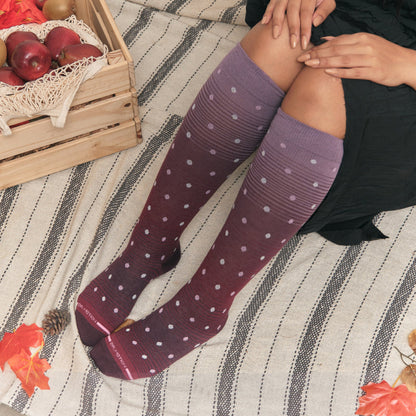 Woman wearing knee high compression socks dots on ombre for daily comfort and circulation