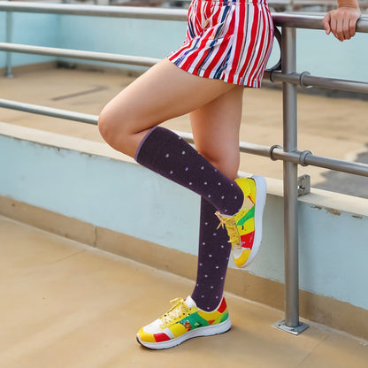 Person wearing colorful sneakers and knee-high socks on a steps background