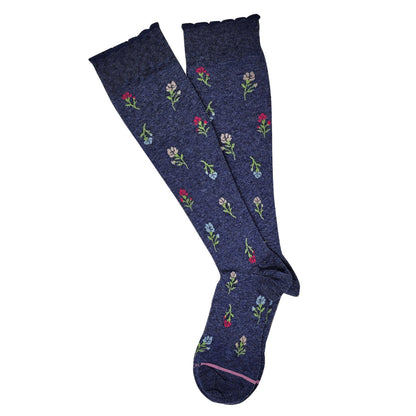 Navy blue knee-high socks with floral patterns on a white background