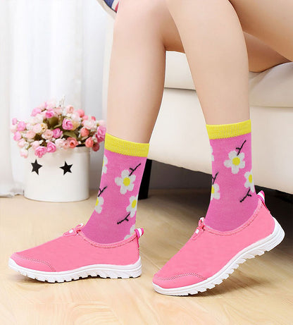 Girls wearing colorful novelty crew socks while playing at home